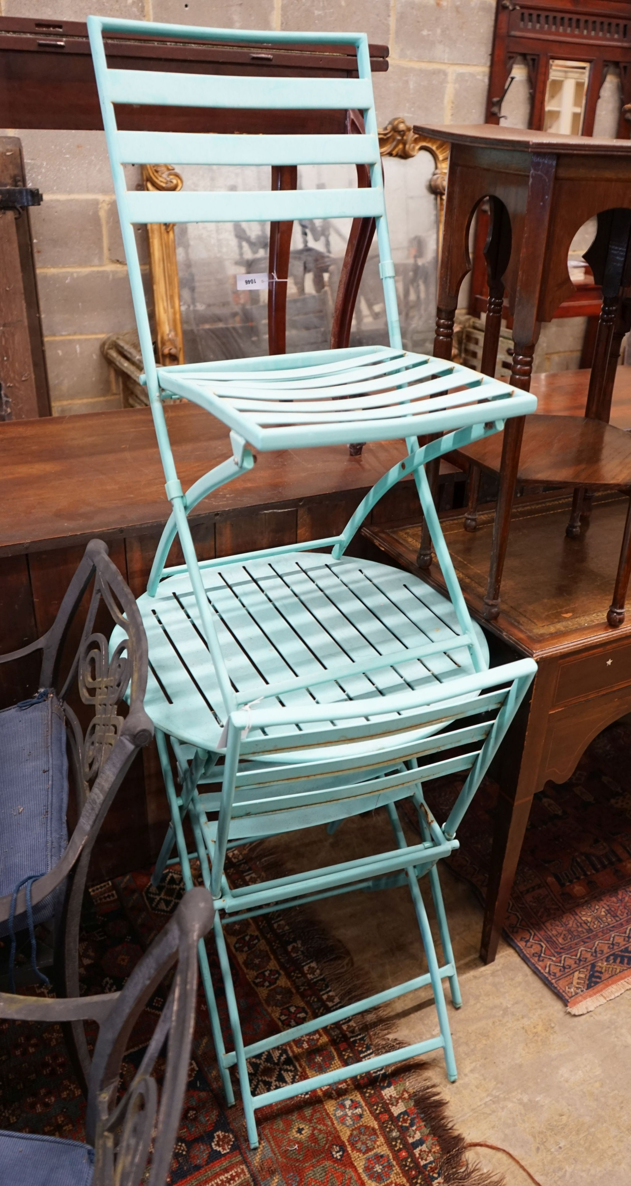 A painted aluminium bistro table, diameter 60cm, height 70cm and two chairs